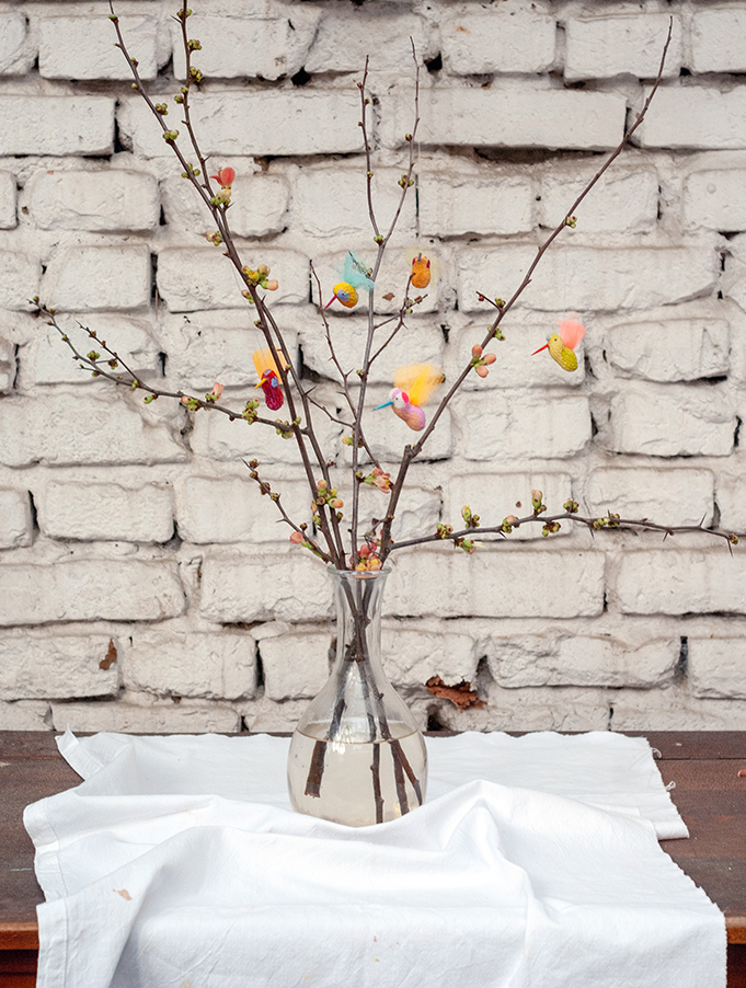 Aus einer einfachen Erdnuss kannst du mit ein wenig Farbe, Tüll und Fantasie herrlich bunte DIY Vogel-Anhänger für deinen Frühlingszweig in der Vase basteln. Tutorial von johannarundel.de